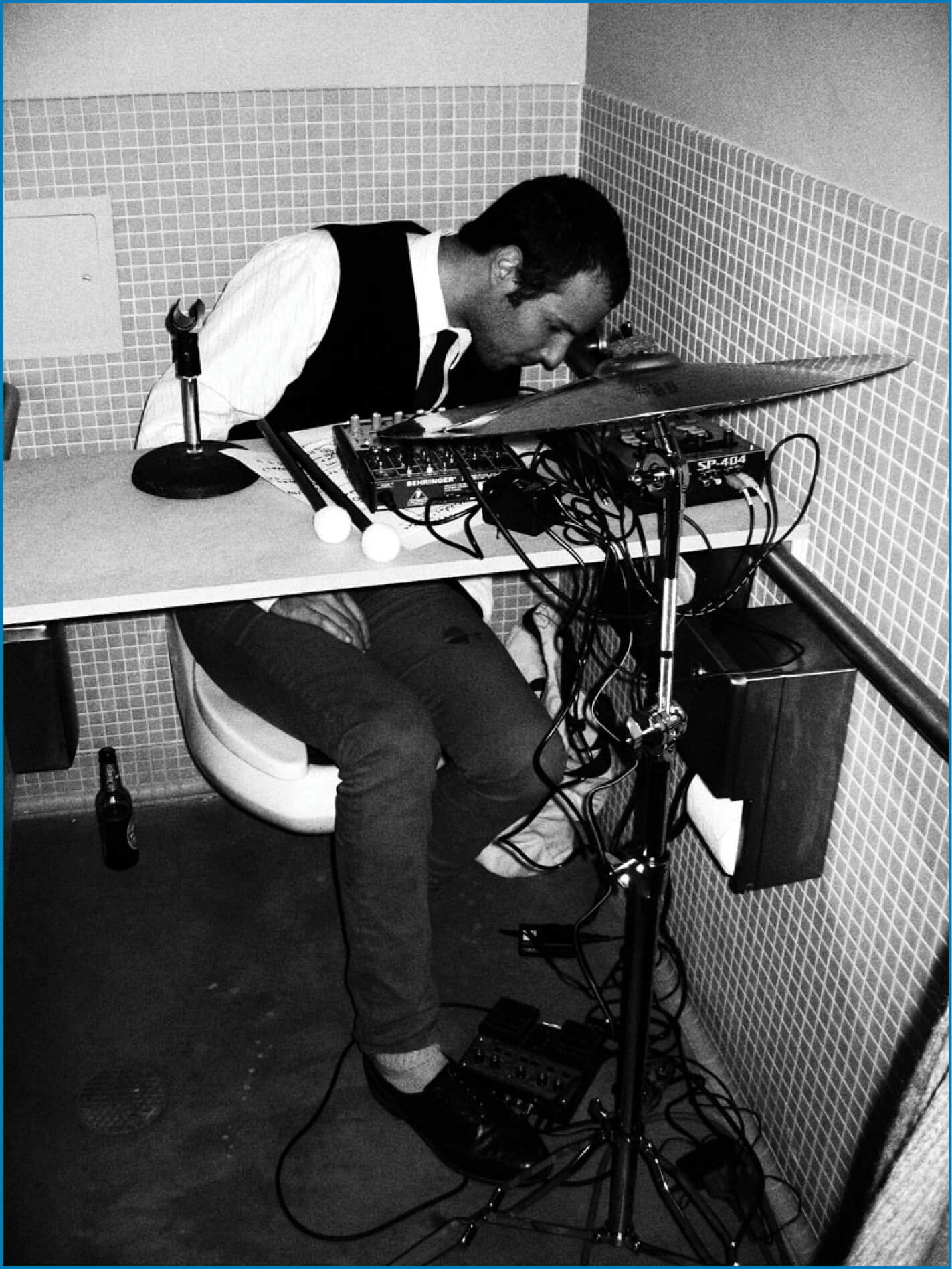 Man child (Sadie Siegel) playing weird music in a bathroom